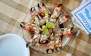Giant crab claws in a dish. Restaurant table
