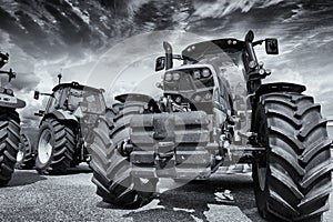 Giant farming tractors and storm clouds