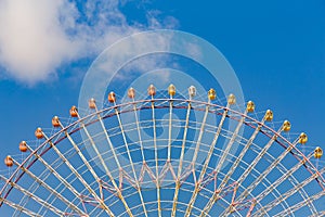 Giant ferris wheel against blue sky