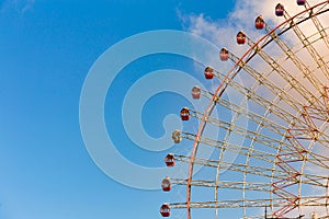 Giant ferris wheel against blue sky and white cloud