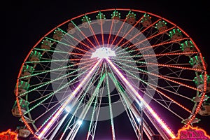 giant Ferris wheel carousel shines in the night sky