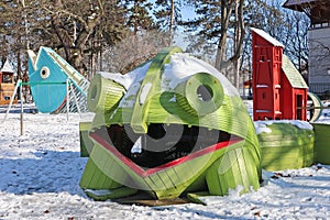 Giant frog toy at the playground in winter time