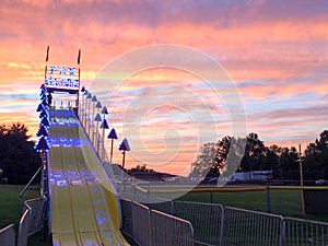 Giant fun slide at fairgrounds at sunset