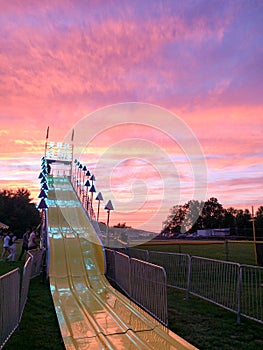 Giant fun slide at fairgrounds at sunset