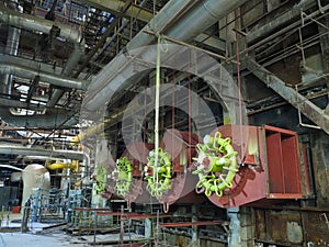 Giant gas-burners, glitter tubes, equipment, cables and piping inside a modern industrial power plant