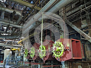 Giant gas-burners, glitter tubes, equipment, cables and piping inside a modern industrial power plant