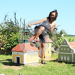 Giant girl kicking belfry in Minimodel of South Bohemian village