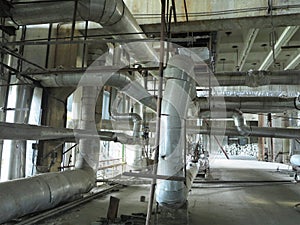 Giant glitter tubes, equipment, cables and piping inside a modern industrial power plant