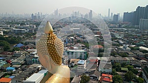 Giant Golden Buddha in Bangkok with a beautiful city skyline in the background