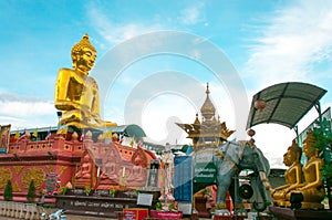 Giant Golden Buddha statue with blue sky Thailand