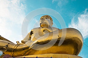 Giant Golden Buddha statue with blue sky Thailand