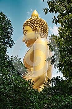 Giant golden buddha statue of Dhammakaya Thep Mongkol Buddha in construction site located at Wat Paknam Bhasicharoen temple