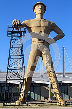 Giant Golden Driller Statue and landmark of oilfield worker and oil derrick near Route 66 in Tulsa Oklahoma