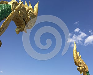 Giant Golden Naga Mythic Serpent Heads and Blue Sky