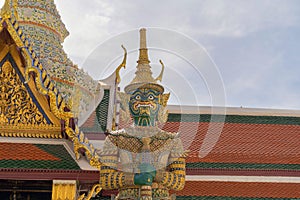 Giant guardian statue of Golden pagoda at Temple of the Emerald Buddha in Bangkok, Thailand. Wat Phra Kaew and Grand palace in old