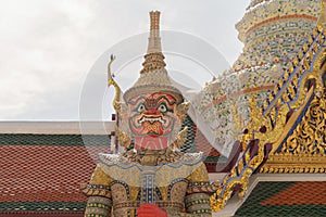 Giant guardian statue of Golden pagoda at Temple of the Emerald Buddha in Bangkok, Thailand. Wat Phra Kaew and Grand palace in old