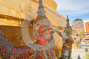 Giant guardian statue of Golden pagoda at Temple of the Emerald Buddha in Bangkok, Thailand. Wat Phra Kaew and Grand palace in old