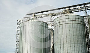 Giant industrial tanks on bright blue sky