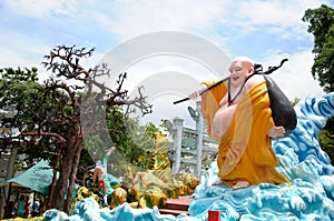 Giant Laughing Buddha statue at Haw Par Villa theme park in Singapore.