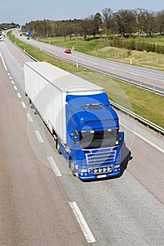 Giant lorry speeding through countryside