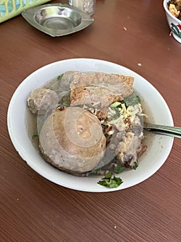 A Giant meatball with bone marrow and yellow noodles