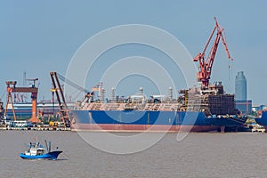 Giant new building gas tanker on shipyard.