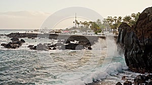 Giant ocean waves crashing and foaming on Shore of Tenerife island with big rock