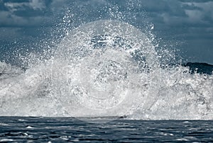 Giant ocean waves crashing in a storm out at sea