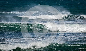 Giant ocean waves crashing in a storm out at sea