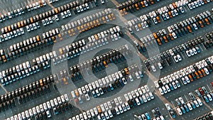 Giant parking of new cars at an automobile factory, aerial view.