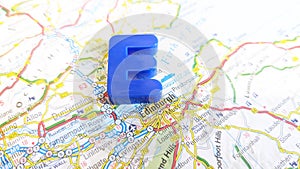 A giant plastic letter E next to Edinburgh on a map of Scotland portrait