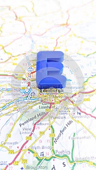 A giant plastic letter E spelling Edinburgh on a map of Scotland portrait