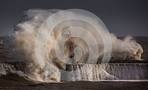 Giant waves batter the 15metre tall lighthouse which guards the south pier at the mouth of the Tyne at South Shields, England