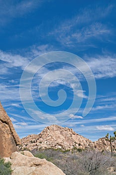 Giant rock formations in the desert and blue sky at Joshua Tree National Park