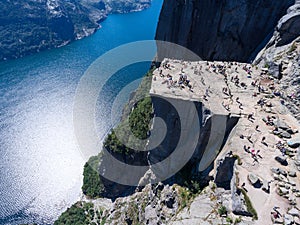 Giant rock Preikestolen over water of fjord Lysefjorden, natural attraction. Top view, flight above cliff. Preacher`s Pulpit or