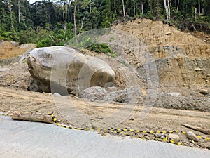 Giant rock beside road after landfall forest