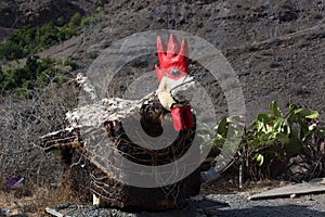 Giant rooster in the garden photo