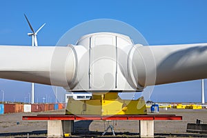 Giant rotors of wind turbine under blue sky photo