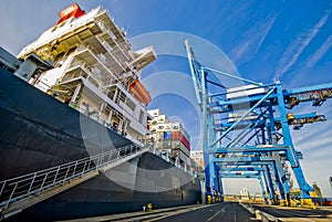 Giant ship moored in container port in uk during cargo transfer operation