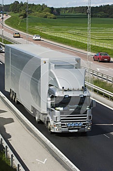 Giant silver-gray lorry in countryside