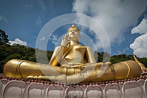 Giant sitting buddha on Rang Hill Temple in Phuket, Thailand