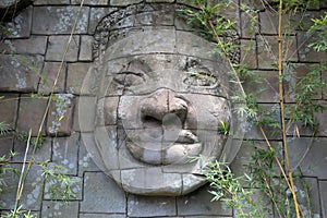 Giant smiling buddha face on a temple wall