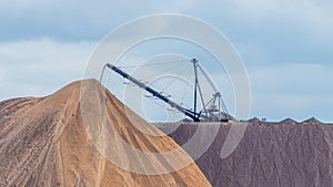 Giant spreader or absetzer machinery. A large dumper on a landfill with potash ore. Extracting potassium salts