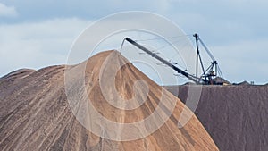 Giant spreader or absetzer machinery. A large dumper on a landfill with potash ore. Extracting potassium salts.