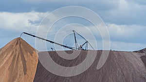 Giant spreader or absetzer machinery. A large dumper on a landfill with potash ore. Extracting potassium salts.