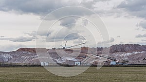 Giant spreader or absetzer machinery. A large dumper on a landfill with potash ore. Extracting potassium salts