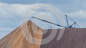 Giant spreader or absetzer machinery. A large dumper on a landfill with potash ore. Extracting potassium salts.