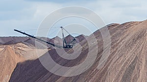 Giant spreader or absetzer machinery. A large dumper on a landfill with potash ore. Extracting potassium salts.