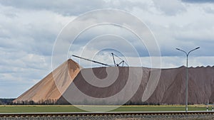 Giant spreader or absetzer machinery. A large dumper on a landfill with potash ore. Extracting potassium salts.