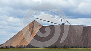 Giant spreader or absetzer machinery. A large dumper on a landfill with potash ore. Extracting potassium salts.